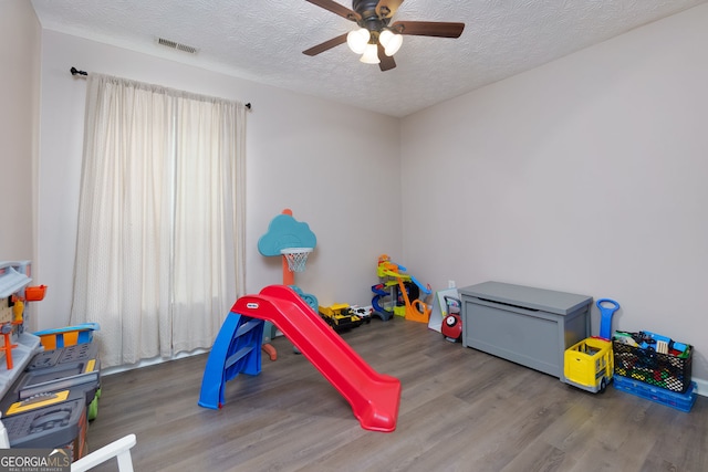 67 Granite Ct, Dallas, GA 30132 - rec room featuring wood finished floors, a ceiling fan, and a textured ceiling