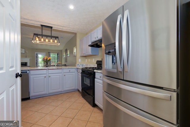 67 Granite Ct, Dallas, GA 30132 - kitchen featuring stainless steel appliances, light tile patterned flooring, under cabinet range hood, a textured ceiling, and hanging light fixtures