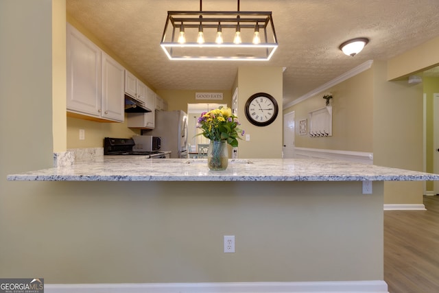 67 Granite Ct, Dallas, GA 30132 - kitchen with gas range, freestanding refrigerator, a textured ceiling, white cabinetry, and a kitchen bar
