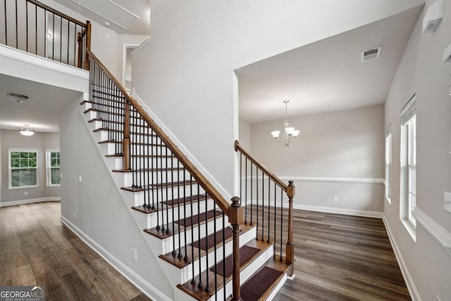 176 Windy Cir, Mcdonough, GA 30253 - staircase featuring wood finished floors and a chandelier