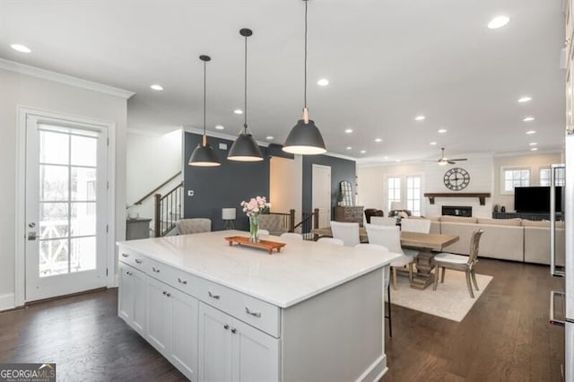385 Rowes Cir, Alpharetta, GA 30009 - kitchen featuring ornamental molding, a center island, ceiling fan, recessed lighting, and a kitchen breakfast bar