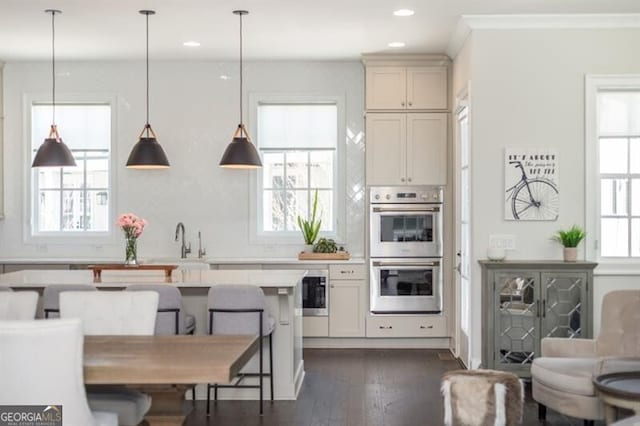 385 Rowes Cir, Alpharetta, GA 30009 - kitchen featuring stainless steel double oven, healthy amount of natural light, light countertops, a breakfast bar, and recessed lighting