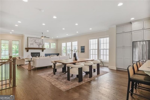 385 Rowes Cir, Alpharetta, GA 30009 - dining area with crown molding, dark wood-type flooring, a ceiling fan, recessed lighting, and a fireplace