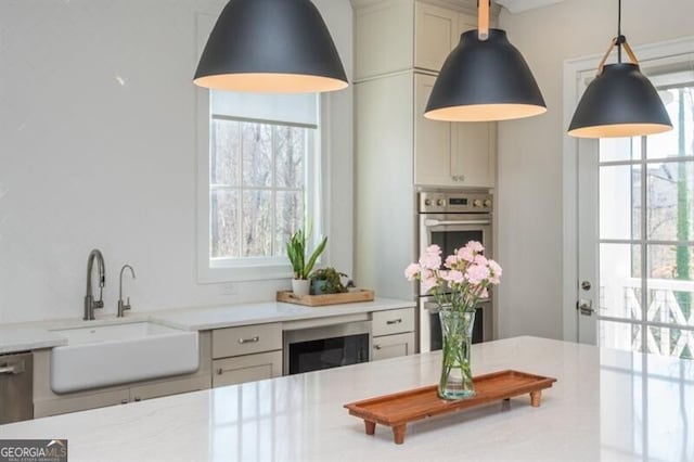 385 Rowes Cir, Alpharetta, GA 30009 - kitchen featuring healthy amount of natural light, hanging light fixtures, light stone counters, and wine cooler