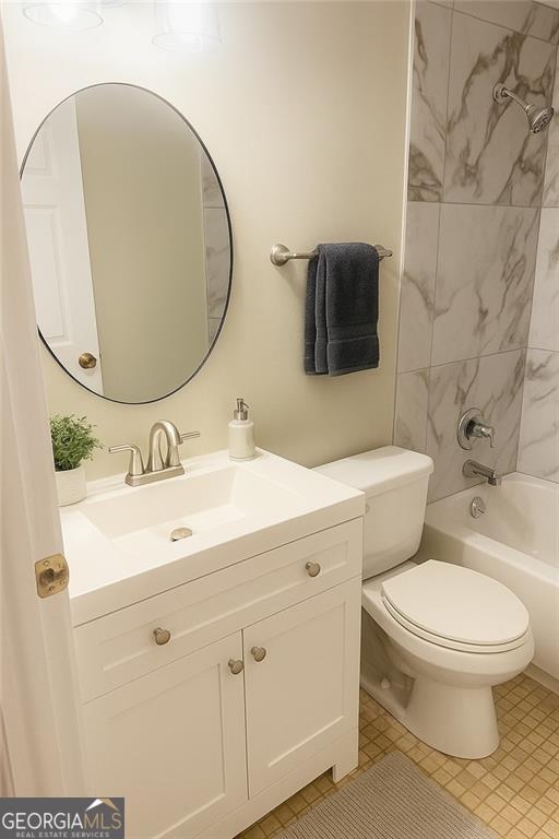 5581 Marbut Rd, Lithonia, GA 30058 - full bath featuring vanity, shower / washtub combination, and tile patterned flooring