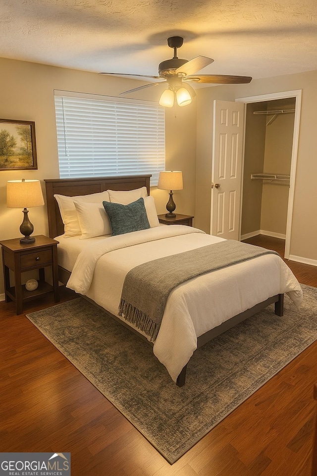 5581 Marbut Rd, Lithonia, GA 30058 - bedroom with wood finished floors, a closet, a ceiling fan, and a textured ceiling