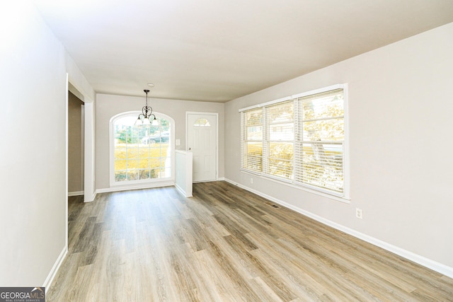 1947 Main St NW, Atlanta, GA 30318 - empty room featuring a chandelier and light wood-style floors