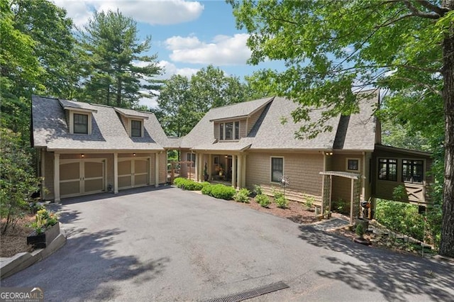 44 Sassafras Rdg, Big Canoe, GA 30143 - view of front of home featuring an outbuilding, driveway, and roof with shingles