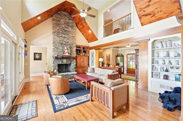 44 Sassafras Rdg, Big Canoe, GA 30143 - living area with a ceiling fan, high vaulted ceiling, wood finished floors, built in features, and a fireplace