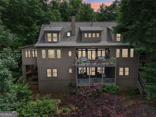 44 Sassafras Rdg, Big Canoe, GA 30143 - rear view of house featuring stairway, a chimney, a shingled roof, and a balcony