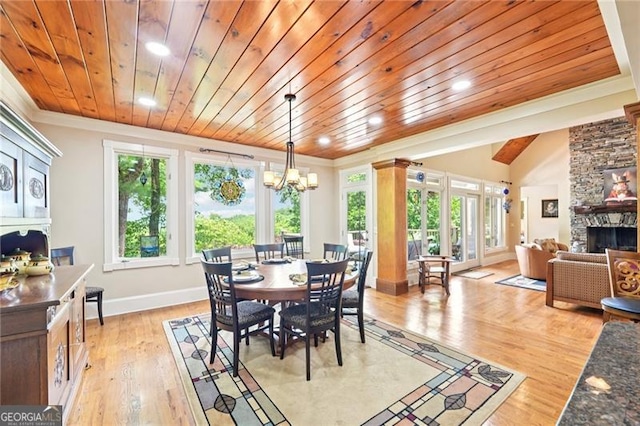 44 Sassafras Rdg, Big Canoe, GA 30143 - dining space with a fireplace, plenty of natural light, ornamental molding, wooden ceiling, and light wood finished floors