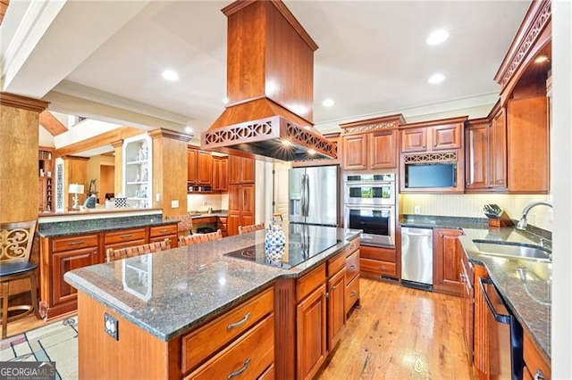 44 Sassafras Rdg, Big Canoe, GA 30143 - kitchen featuring appliances with stainless steel finishes, crown molding, light wood-style flooring, a kitchen island, and dark stone countertops