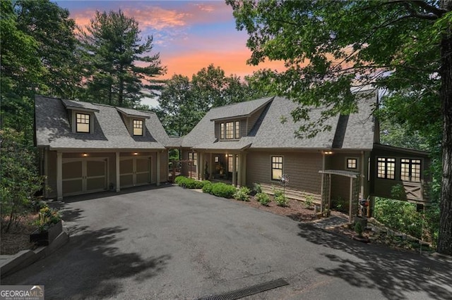 44 Sassafras Rdg, Big Canoe, GA 30143 - view of front of home featuring an outdoor structure, driveway, a shingled roof, and a garage