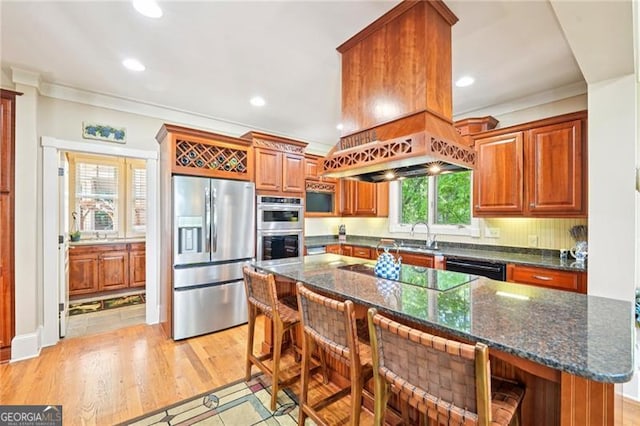44 Sassafras Rdg, Big Canoe, GA 30143 - kitchen with black appliances, ornamental molding, a breakfast bar, recessed lighting, and dark stone countertops