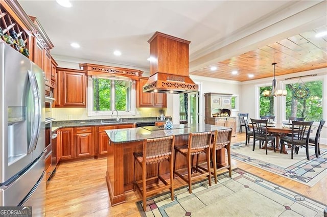 44 Sassafras Rdg, Big Canoe, GA 30143 - kitchen featuring stainless steel fridge with ice dispenser, light wood-style flooring, ornamental molding, a breakfast bar area, and brown cabinetry