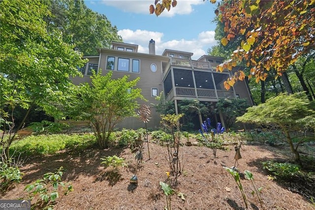 44 Sassafras Rdg, Big Canoe, GA 30143 - rear view of house with a chimney and a sunroom