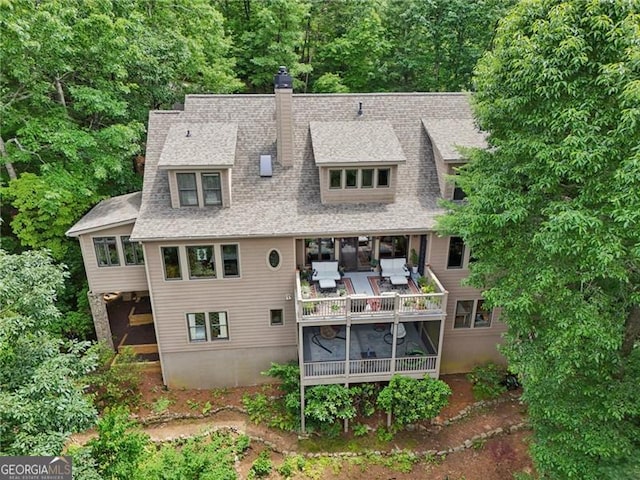 44 Sassafras Rdg, Big Canoe, GA 30143 - back of property featuring a chimney, a sunroom, and roof with shingles