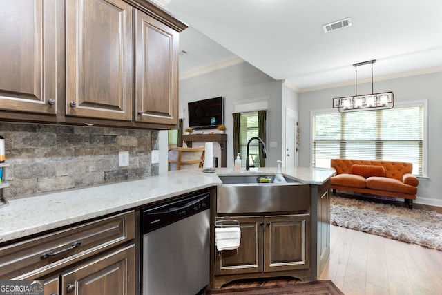300 Bridgehampton Way, Perry, GA 31069 - kitchen featuring stainless steel dishwasher, crown molding, wood finished floors, a peninsula, and tasteful backsplash