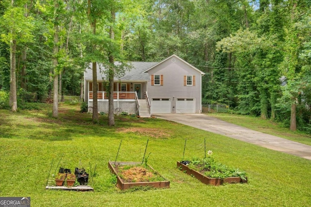 425 Shelby Ln, Hiram, GA 30141 - split level home featuring a vegetable garden, an attached garage, driveway, stairs, and a porch
