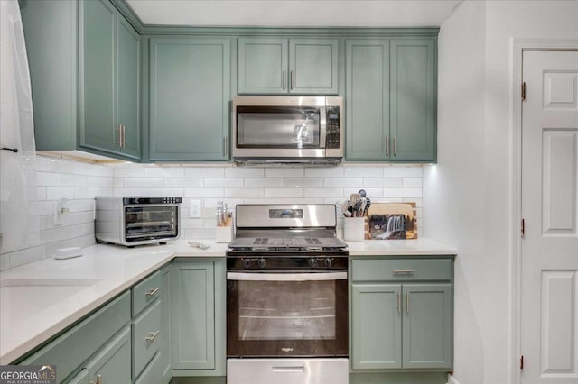425 Shelby Ln, Hiram, GA 30141 - kitchen featuring stainless steel appliances, green cabinets, and light countertops