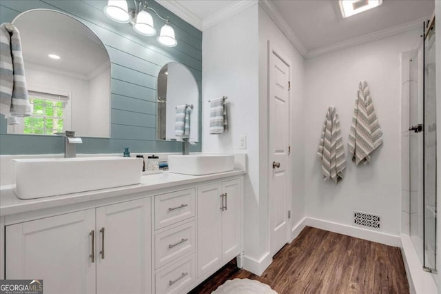 425 Shelby Ln, Hiram, GA 30141 - full bathroom featuring wood finished floors, double vanity, crown molding, and a shower