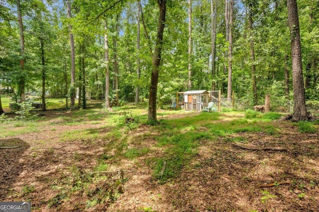 425 Shelby Ln, Hiram, GA 30141 - view of yard with an outdoor structure and a forest view