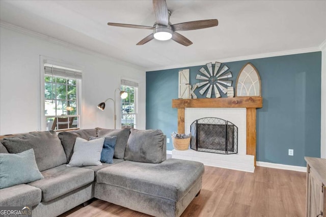 425 Shelby Ln, Hiram, GA 30141 - living room featuring ornamental molding, wood finished floors, ceiling fan, and a brick fireplace