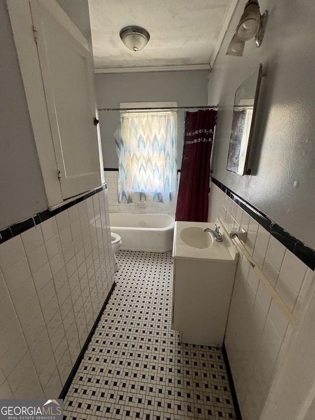 1182 Brentwood Ave, Macon, GA 31204 - full bathroom with tile walls, a bathtub, ornamental molding, wainscoting, and vanity