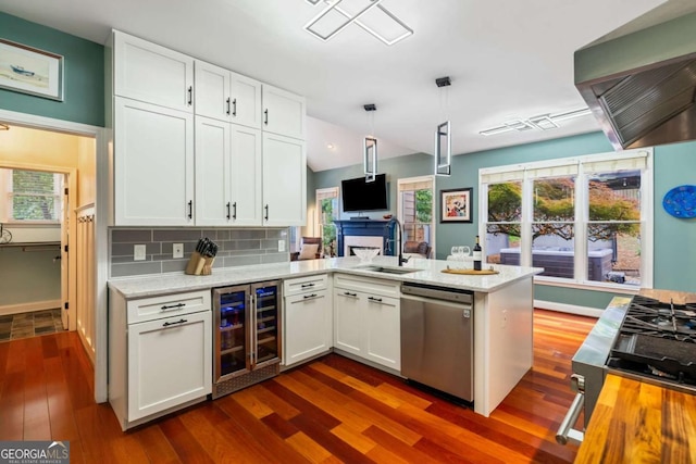425 Starfire Ct, Suwanee, GA 30024 - kitchen with beverage cooler, dishwasher, wall chimney exhaust hood, and white cabinets