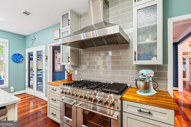 425 Starfire Ct, Suwanee, GA 30024 - kitchen featuring wall chimney range hood, range with two ovens, wood counters, and decorative backsplash