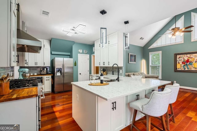 425 Starfire Ct, Suwanee, GA 30024 - kitchen with stainless steel appliances, butcher block counters, tasteful backsplash, dark wood-style flooring, and high vaulted ceiling