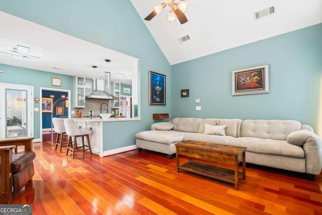 425 Starfire Ct, Suwanee, GA 30024 - living room featuring a ceiling fan, wood finished floors, and high vaulted ceiling