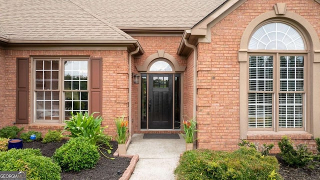 425 Starfire Ct, Suwanee, GA 30024 - doorway to property featuring brick siding and a shingled roof