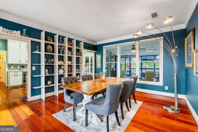 425 Starfire Ct, Suwanee, GA 30024 - dining area with beverage cooler, crown molding, wood finished floors, and healthy amount of natural light