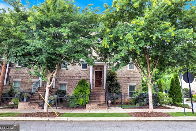 326 Brownstones Cir NE, Atlanta, GA 30312 - view of front of home with a fenced front yard and brick siding