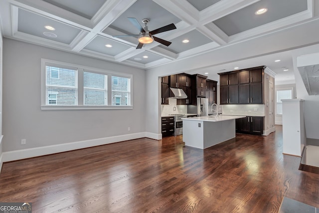 326 Brownstones Cir NE, Atlanta, GA 30312 - kitchen with under cabinet range hood, light countertops, plenty of natural light, dark brown cabinetry, and coffered ceiling