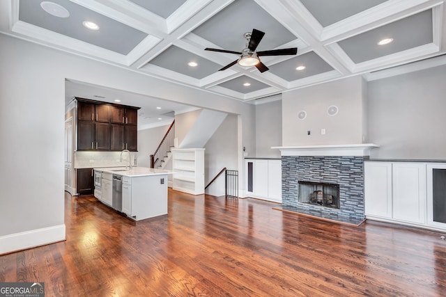 326 Brownstones Cir NE, Atlanta, GA 30312 - unfurnished living room featuring dark wood-type flooring, ceiling fan, beamed ceiling, coffered ceiling, and stairs
