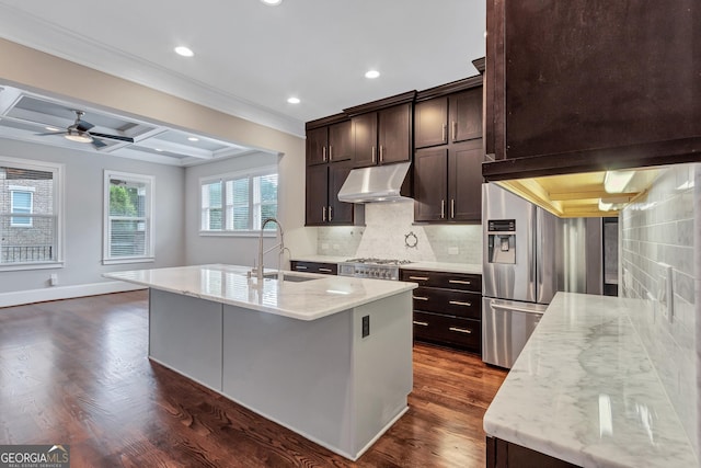 326 Brownstones Cir NE, Atlanta, GA 30312 - kitchen featuring under cabinet range hood, crown molding, light stone counters, dark brown cabinetry, and decorative backsplash