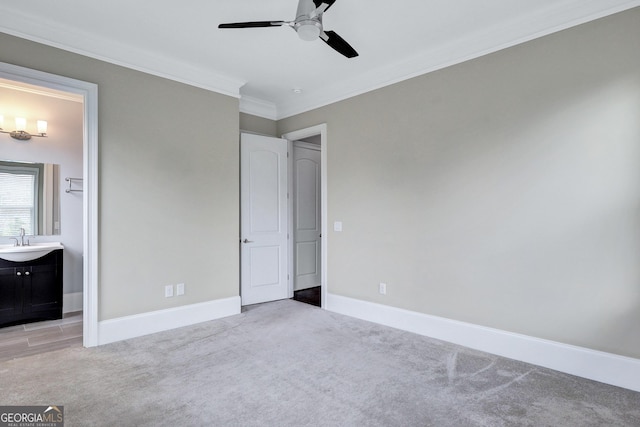 326 Brownstones Cir NE, Atlanta, GA 30312 - unfurnished bedroom featuring light colored carpet, ornamental molding, ensuite bathroom, and a ceiling fan