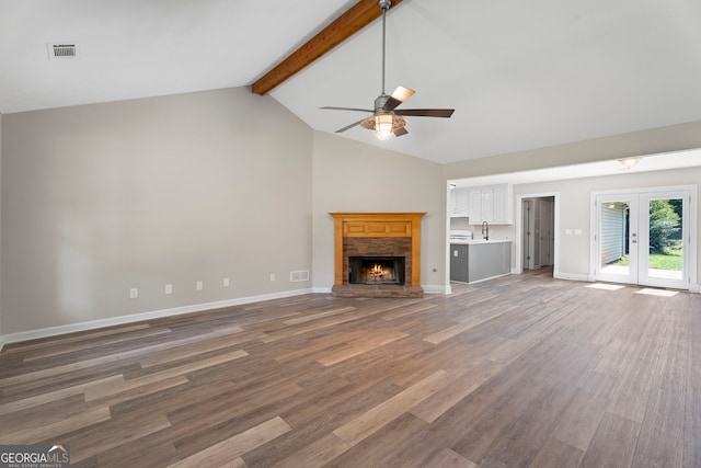 312 Cattlemans Cir, Mcdonough, GA 30252 - unfurnished living room with a ceiling fan, a fireplace, and wood finished floors