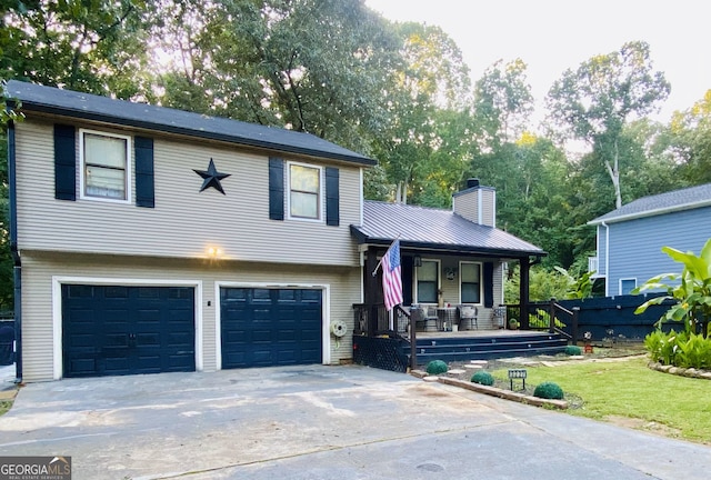 3227 Due W Rd, Dallas, GA 30157 - split level home featuring a porch, a garage, driveway, and a chimney