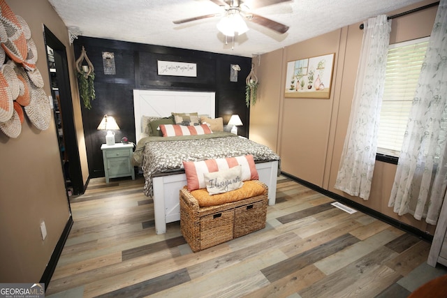 3227 Due W Rd, Dallas, GA 30157 - bedroom featuring light wood-style flooring, a textured ceiling, and a ceiling fan