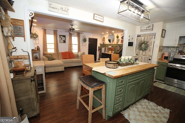 3227 Due W Rd, Dallas, GA 30157 - kitchen with green cabinetry, stainless steel gas range, butcher block counters, a breakfast bar, and a ceiling fan