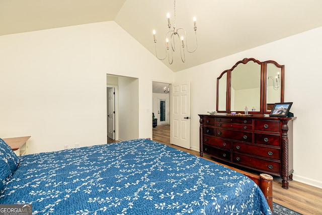 7140 Timberbrooke Dr, Gainesville, GA 30506 - bedroom featuring a chandelier, wood finished floors, and high vaulted ceiling