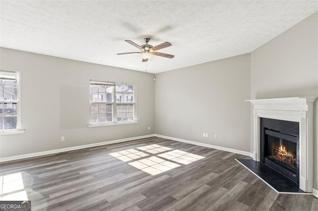 5667 Cascade, Atlanta, GA 30336 - unfurnished living room with a warm lit fireplace, wood finished floors, ceiling fan, and a textured ceiling