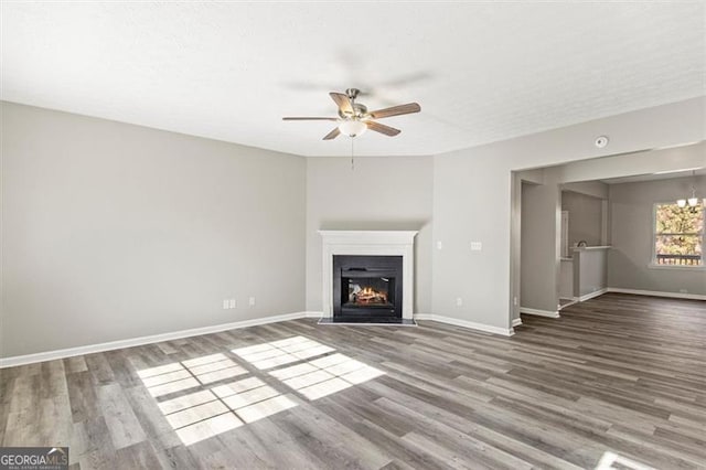 5667 Cascade, Atlanta, GA 30336 - unfurnished living room featuring a ceiling fan, wood finished floors, and a fireplace with flush hearth