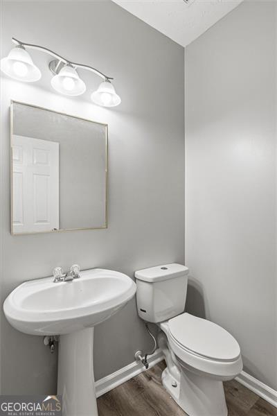 5667 Cascade, Atlanta, GA 30336 - bathroom featuring wood finished floors and toilet