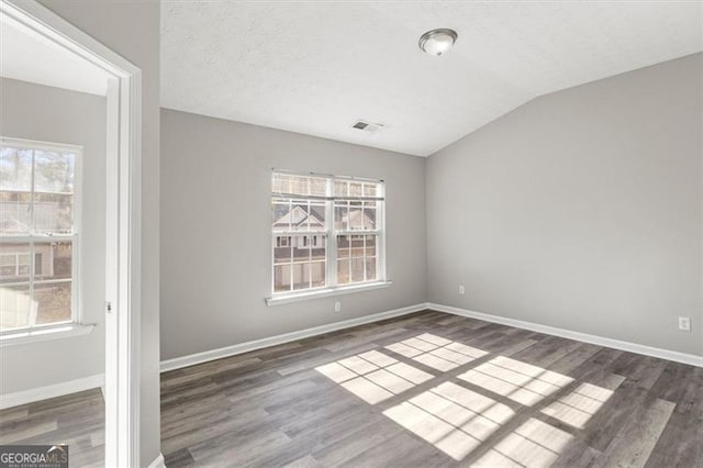 5667 Cascade, Atlanta, GA 30336 - spare room featuring wood finished floors, plenty of natural light, and vaulted ceiling