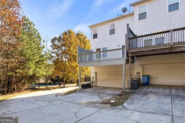 5667 Cascade, Atlanta, GA 30336 - rear view of property featuring a balcony, an attached garage, and concrete driveway