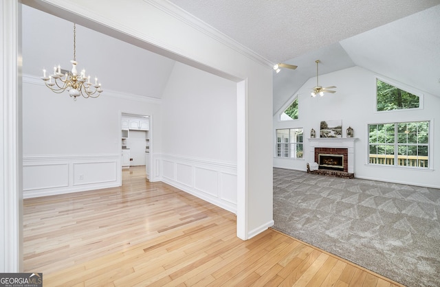 110 Chardonnay Oaks Dr, Mcdonough, GA 30252 - unfurnished living room featuring vaulted ceiling, a chandelier, hardwood / wood-style flooring, wainscoting, and a ceiling fan